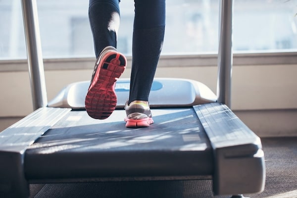 A resident running on a treadmill at Ivy Interbay apartment's gym