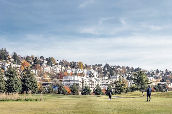 Two people golfing at the Interbay Golf Center near Ivy Interbay apartments neighborhood