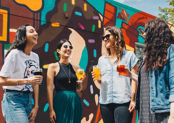 Four women drinking beer