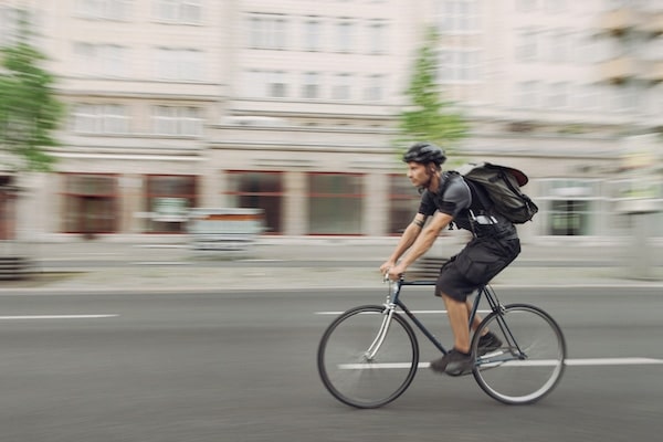 A bicycle messenger riding near Ivy Interbay apartment's bike paths