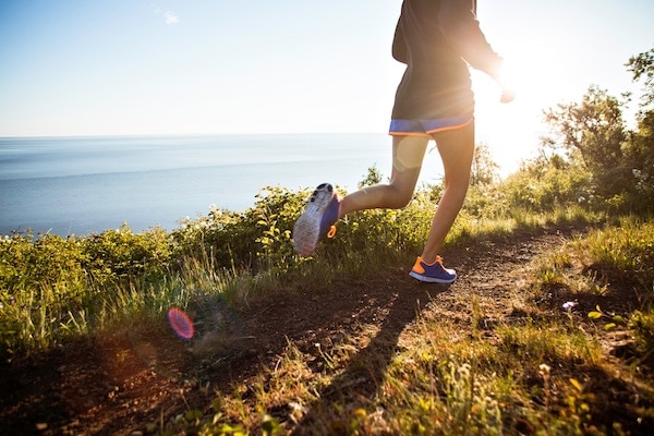 A person running on a hiking trail near Ivy Interbay apartments.